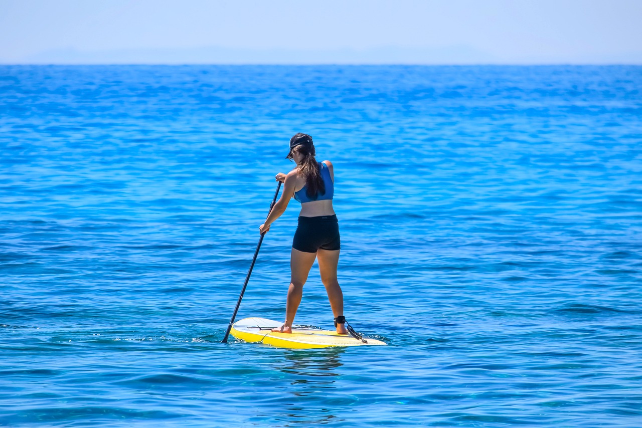 A woman paddleboarding in Orlando